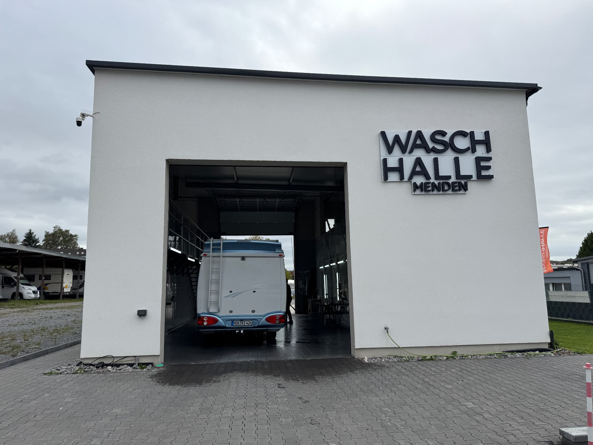 Außenansicht der Waschhalle Menden mit Wohnmobil in der offenen Halle